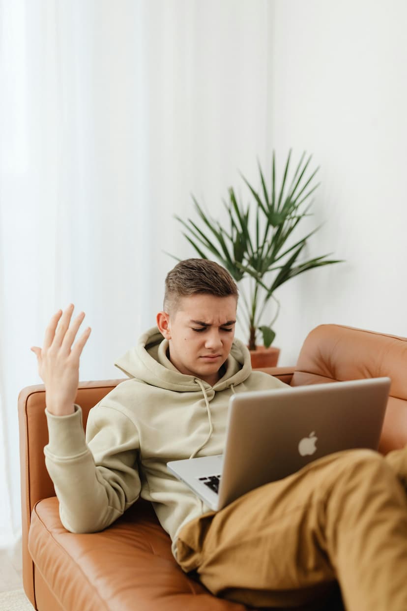 Person looking frustrated while working on laptop